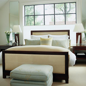 bedroom w/ cream and dark wood furniture