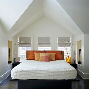 bed in nook with  bright pillows