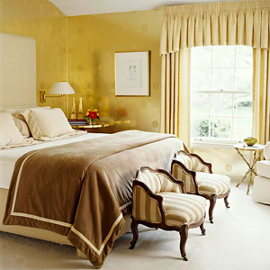 bedroom w/two small chairs at end of bed