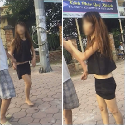Hình ảnh cô gái chạy ra lao đầu vào ô tô được một người đàn ông kéo vào vỉa hè. Ảnh cắt từ clip Hình ảnh cô gái chạy ra lao đầu vào ô tô được một người đàn ông kéo vào vỉa hè. Ảnh cắt từ clip