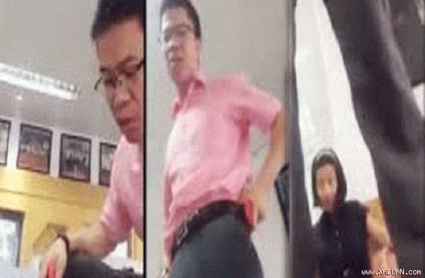 Ông Phan Văn Hưng nhảy lên bàn chửi tục học viên (ảnh chụp từ clip)