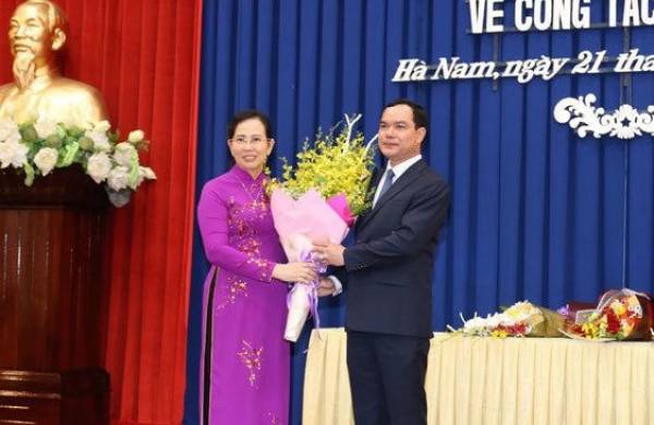 Ông Nguyễn Đình Khang, nguyên Bí thư Tỉnh ủy tặng hoa chúc mừng tân Bí thư Tỉnh ủy Hà Nam Lê Thị Thủy. ảnh: Báo Giao thông