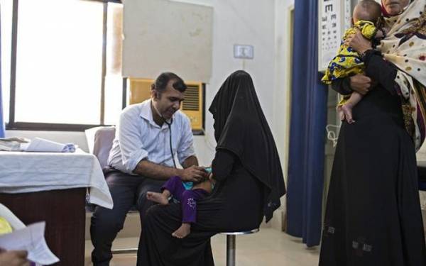 Bác sĩ khám bệnh cho trẻ em tại Ratodero, Pakistan ngày 23/10. Ảnh: The New York Times.