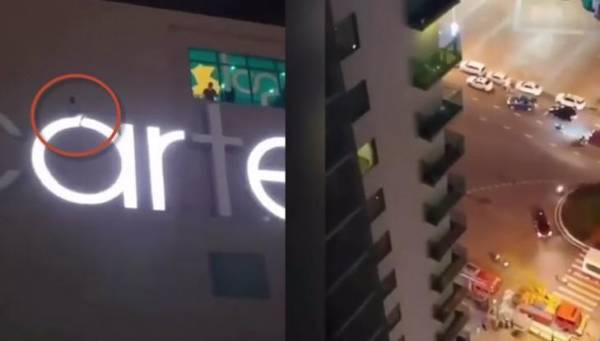 Thót tim nam thanh niên đập cửa kính, ngồi vắt vẻo trên logo khách sạn ở tầng 20